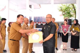 Pj Wali Kota Kotamobagu, Asripan Nani saat menyerahkan SPPDT PBB, (Foto: Diskominfo).