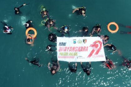 Kompak para Diver berhasil kibarkan spanduk di dasar laut desa Sondana. (Dok pribadi).